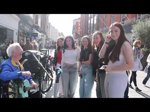 A Group of Dublin Girls stop to sing along with Legendary Busker Jimmy C